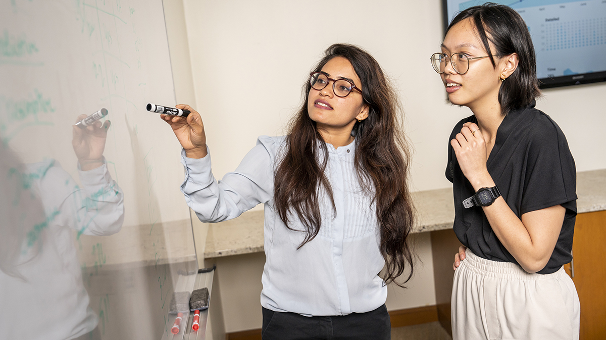 LeBow students working on the whiteboard