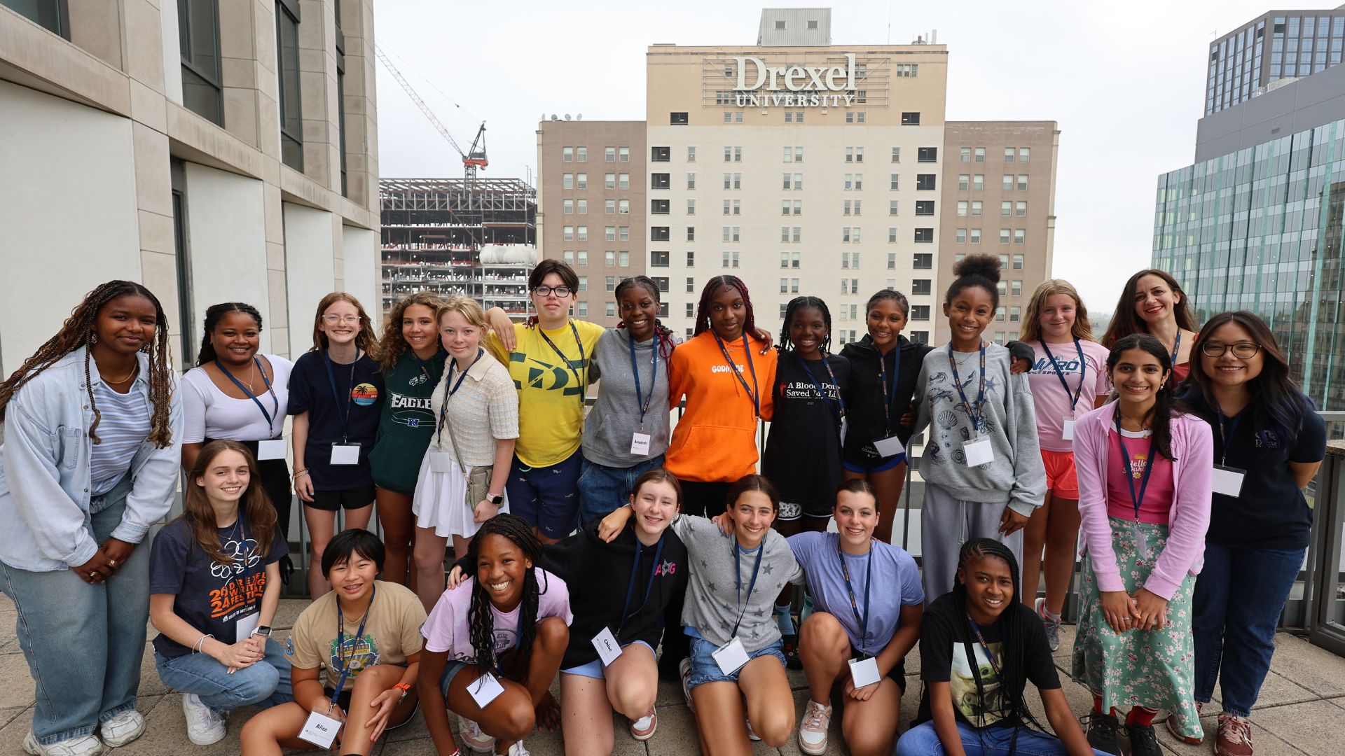 Girls in STEM participants pose in front of Drexel sign.