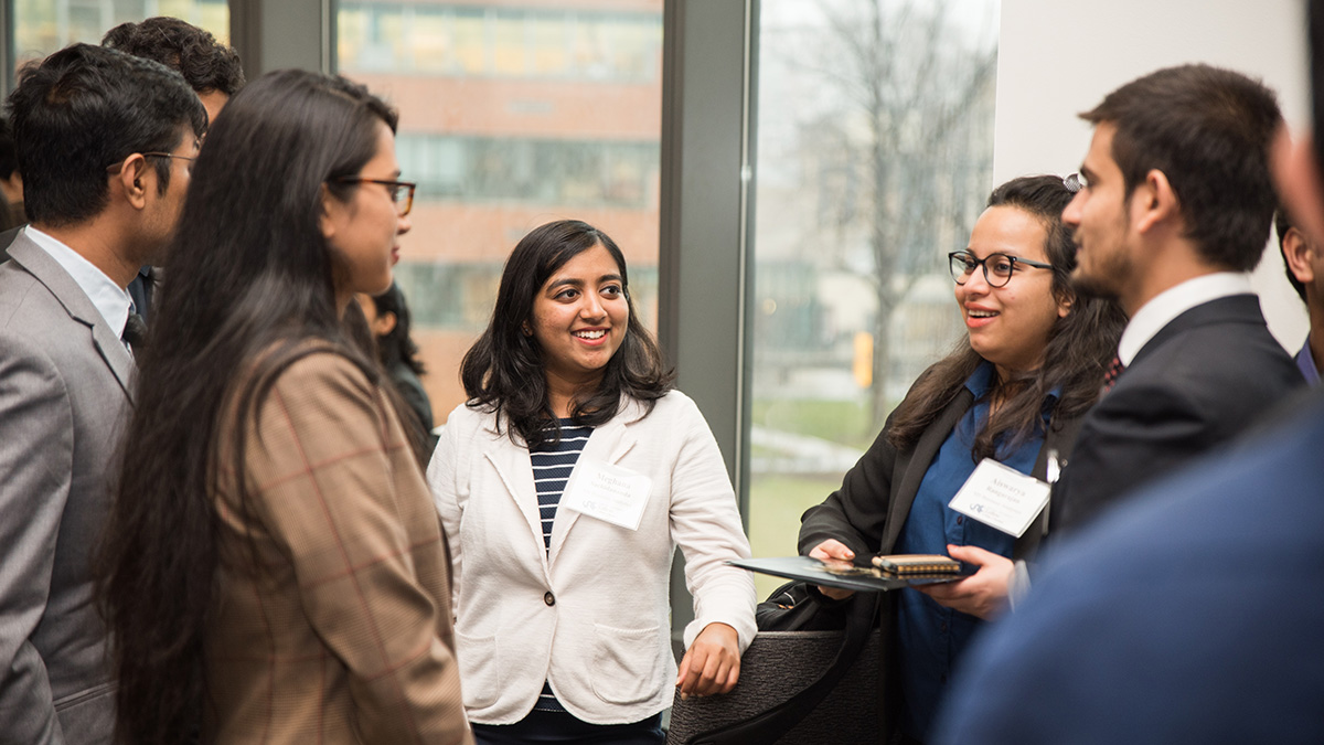 a group of grad students chatting together during an event