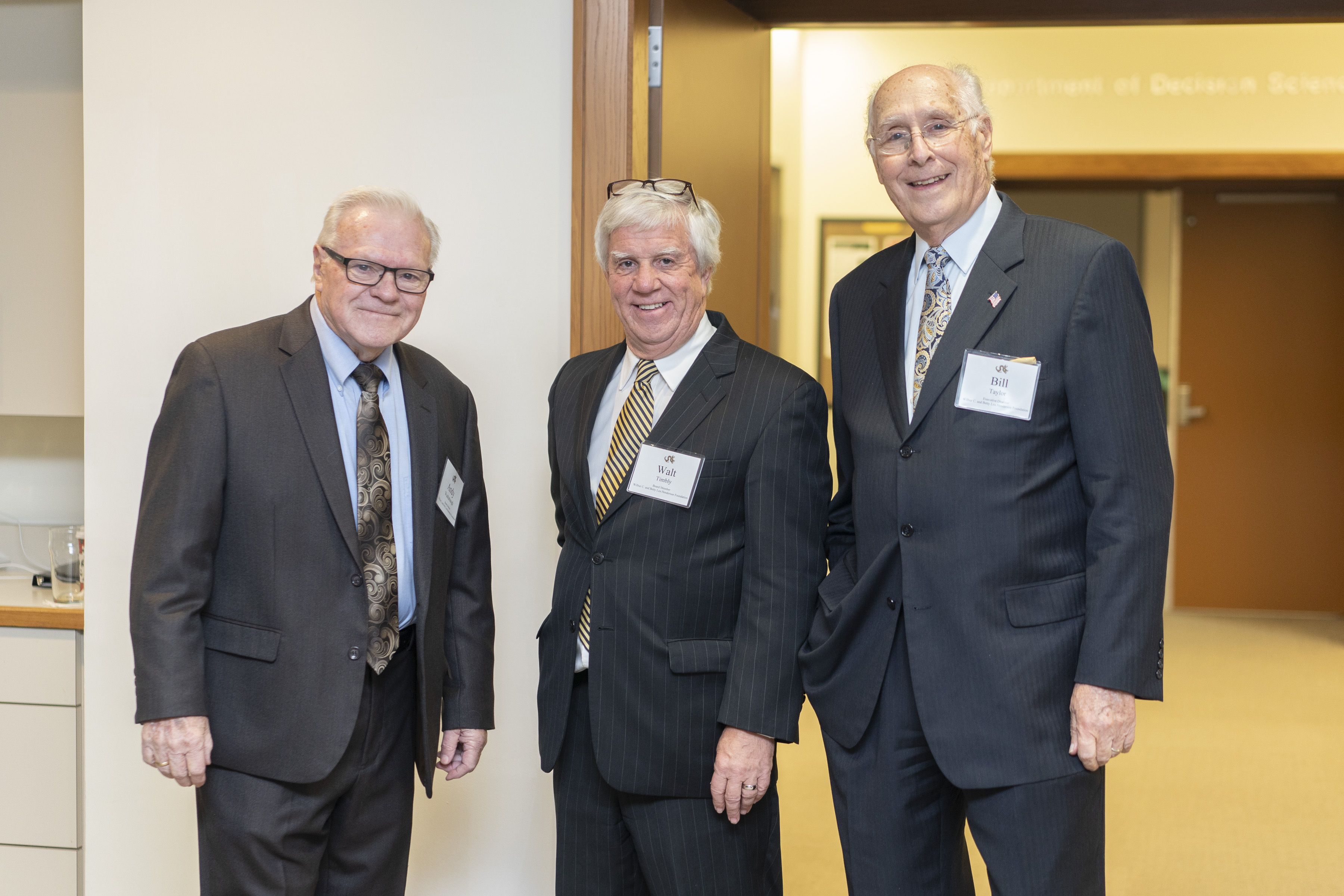 Three men in suits standing together