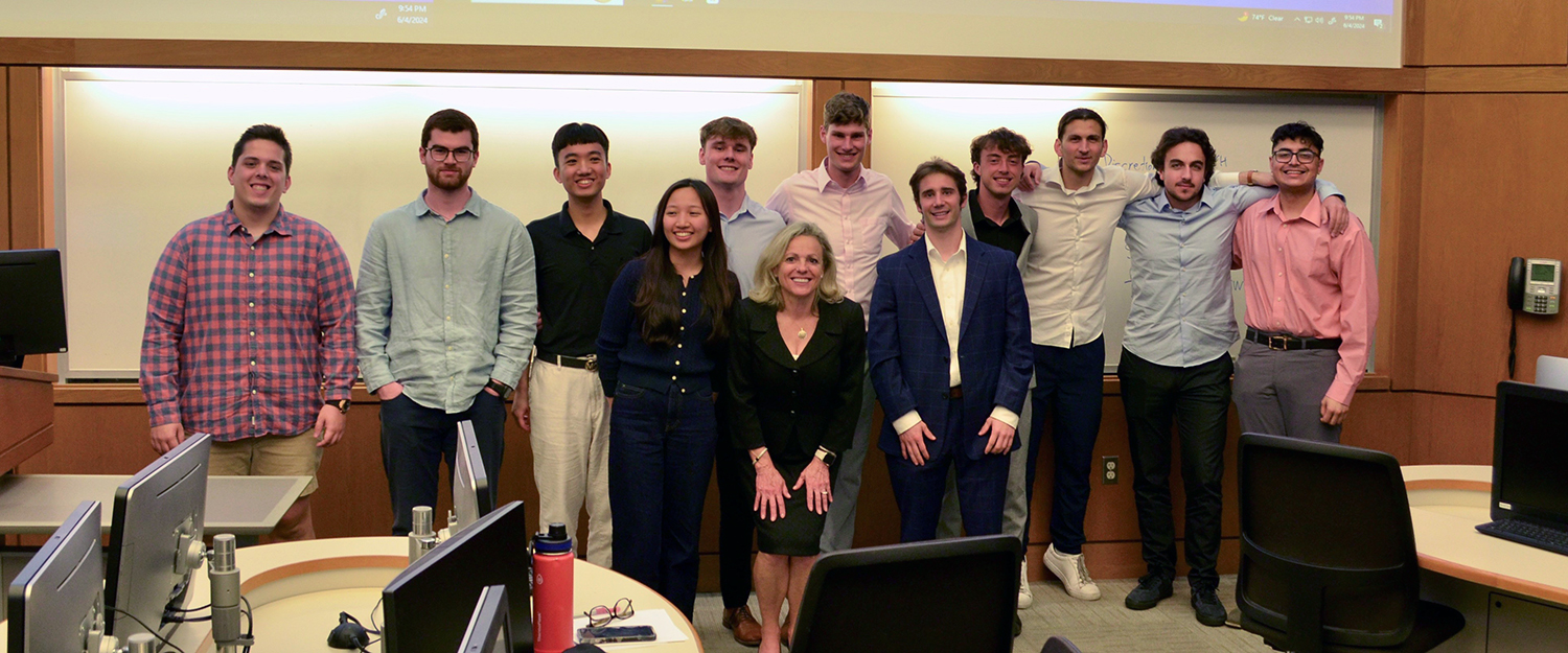 Retiring Professor Diana Sandberg poses with students and alumni during her final Dragon Fund class