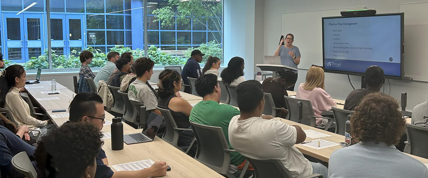 Students in a classroom in Drexel's Academic Resource Center with instructor at the front next to a screen