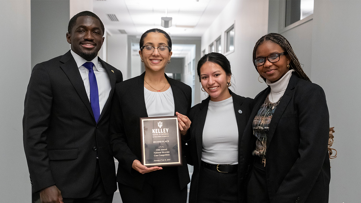 One male and three female students dressed in business attire