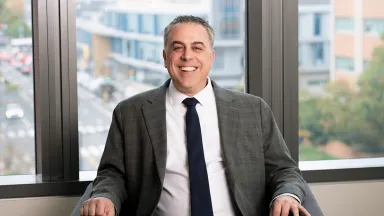 Thomas Baselice with Drexel's Philadelphia campus visible through the window behind him