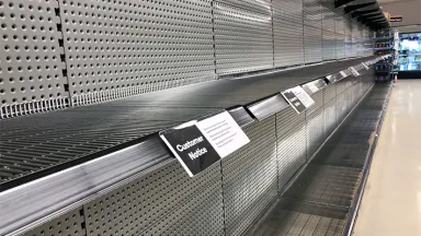 Empty shelves in the toilet paper aisle