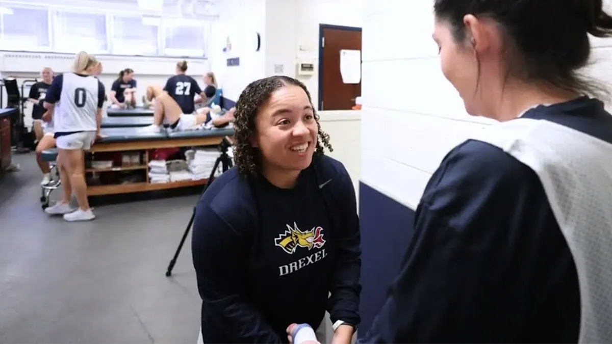 Cayla Williams works with student as an athletic trainer.