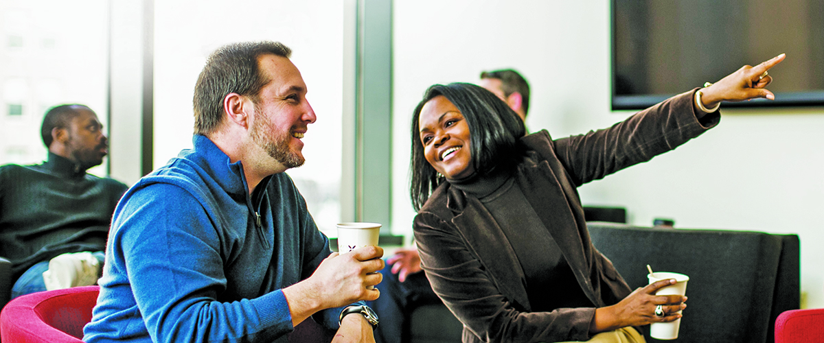 executive MBAs share a cup of coffee as they chat